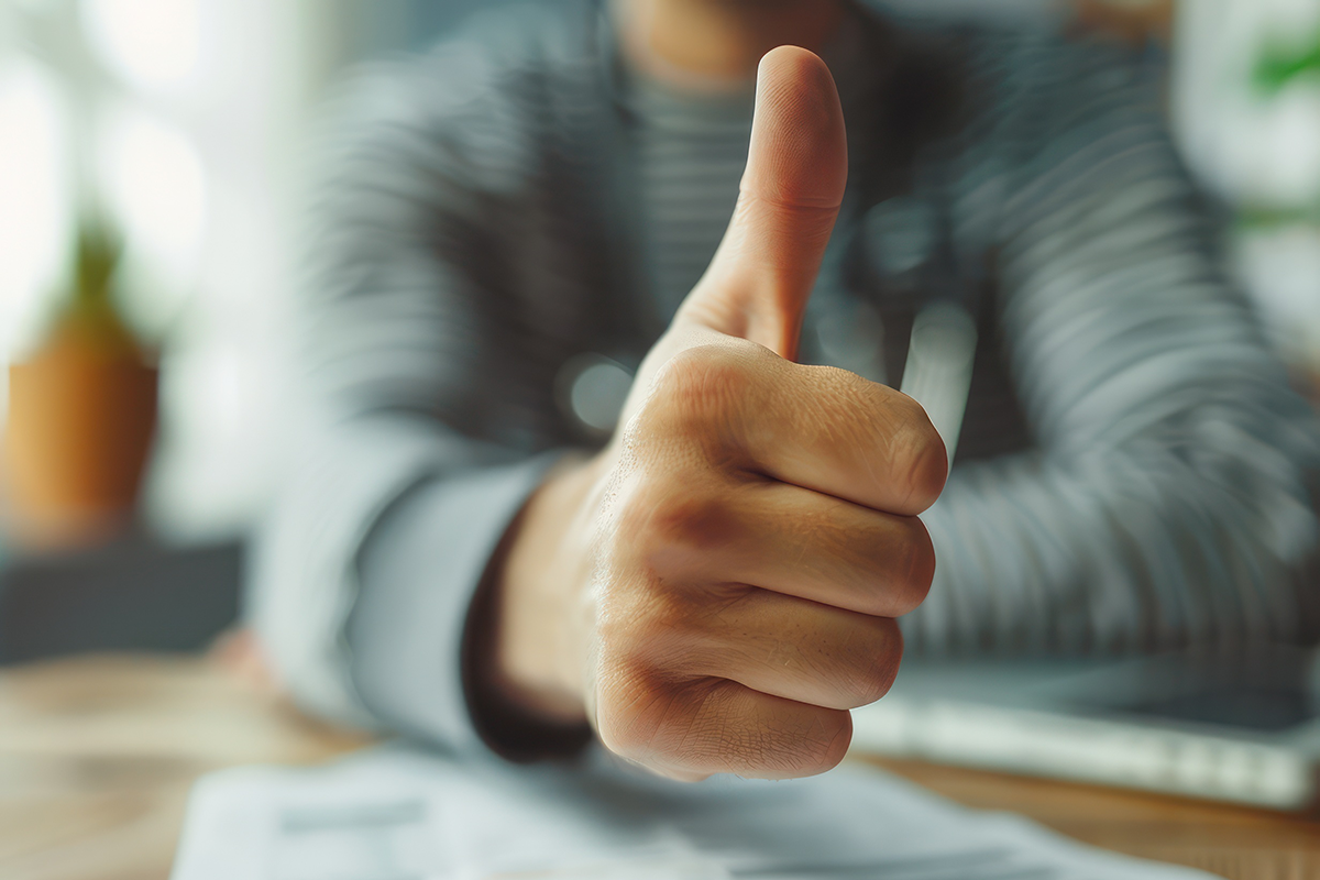 Close-up of a patient giving a thumbs up