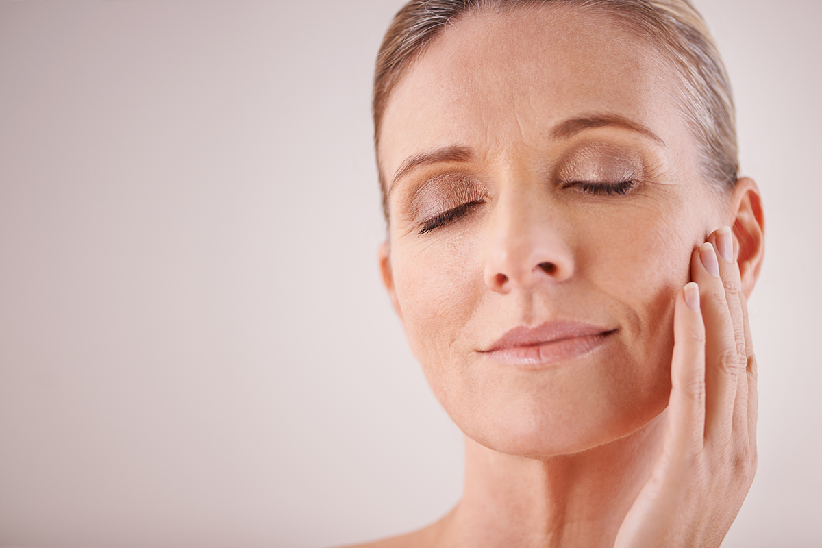 Cropped studio shot of a beautiful mature woman touching her face
